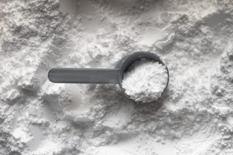 tablespoon filled with white creatine powder